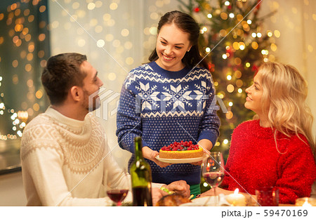 happy friends having christmas dinner at home 59470169