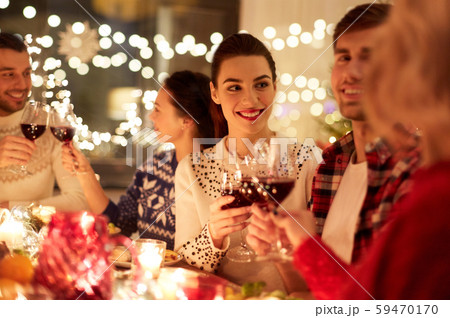 happy friends celebrating christmas at home feast 59470170