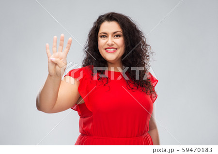 happy woman in red dress showing four fingers 59470183