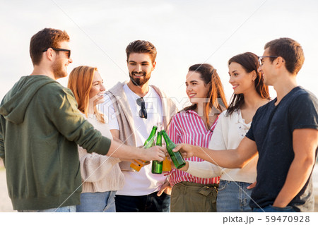 friends toasting non alcoholic drinks on beach 59470928