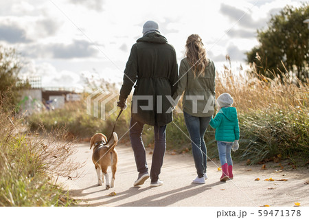 happy family walking with dog in autumn 59471378