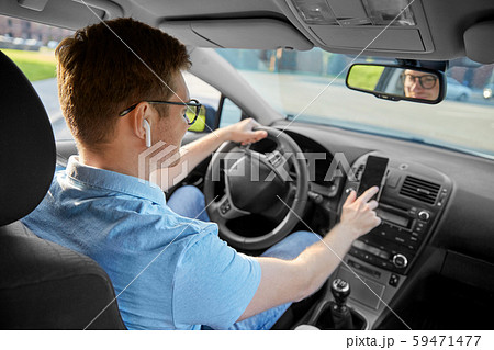 man driving car and using gps on smartphone 59471477