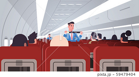 steward explaining for passengers how to use seat belt fastening in emergency situation male flight 59479404