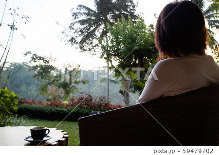 A beautiful young woman drnking tea and relaxing in the morning A beautiful young woman drnking tea and relaxing in the morning 59479702