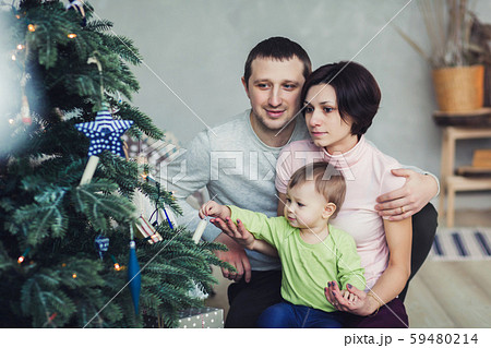 little girl decorating Christmas tree little girl decorating Christmas tree 59480214