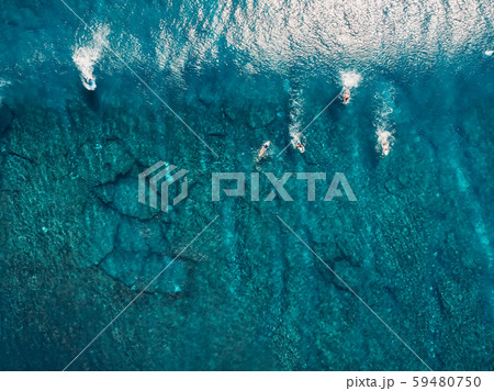 Aerial view with surfers and wave in crystal blue ocean. Top view Aerial view with surfers and wave in crystal blue ocean. Top view 59480750