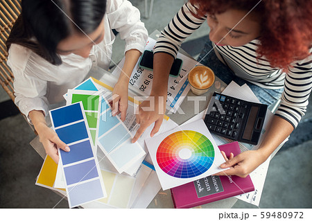 Top view of designers looking at color palette Top view of designers looking at color palette 59480972