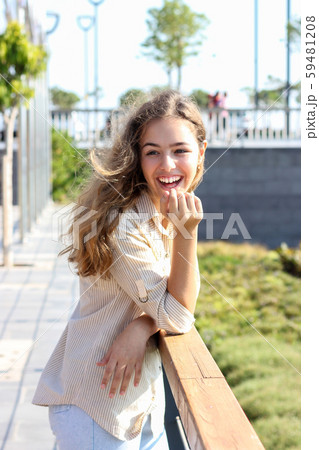 Happy young teenager girl smiling on a sunny day. 59481208