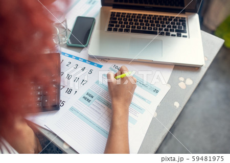 Woman calculating money and filling tax declaration Woman calculating money and filling tax declaration 59481975