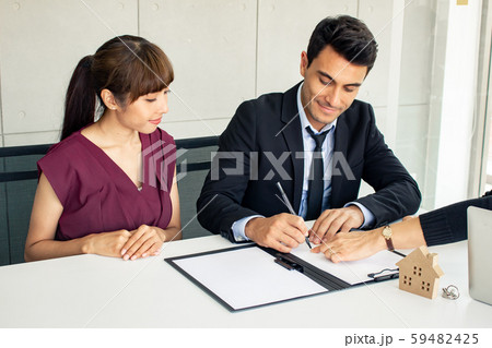 Husband and wife consult with the owner on the 59482425