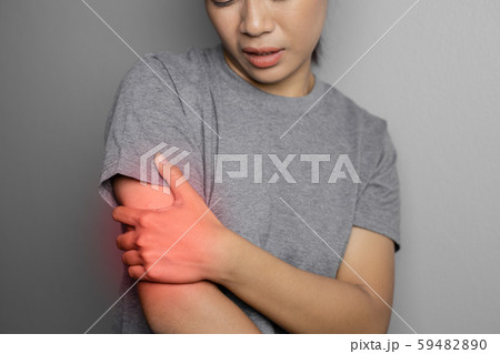 Woman suffering from pain in arm. Woman suffering from pain in arm. 59482890