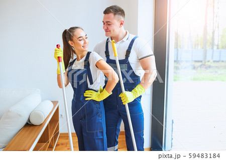 Team of two caucasian janitors stand together Team of two caucasian janitors stand together 59483184