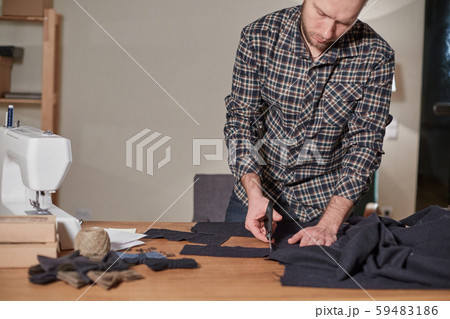 Tailor cutting wool fabric. the line pattern. Craftsman Makes rectangular blanks for Bow ties of Tailor cutting wool fabric. the line pattern. Craftsman Makes rectangular blanks for Bow ties of 59483186