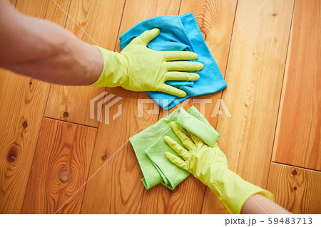 Hands in yellow protective glove cleaning floor with rag Hands in yellow protective glove cleaning floor with rag 59483713