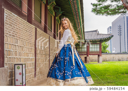 Young caucasian female tourist in hanbok national korean dress at Gyeongbokgung Palace. Travel to Young caucasian female tourist in hanbok national korean dress at Gyeongbokgung Palace. Travel to 59484154