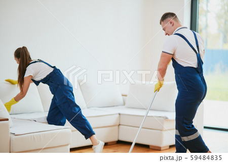 Young cleaners with professional equipment during work 59484835