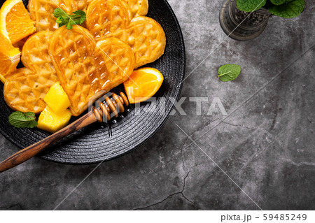 Healthy breakfast with fresh hot waffles hearts, pancakes flowers Healthy breakfast with fresh hot waffles hearts, pancakes flowers 59485249