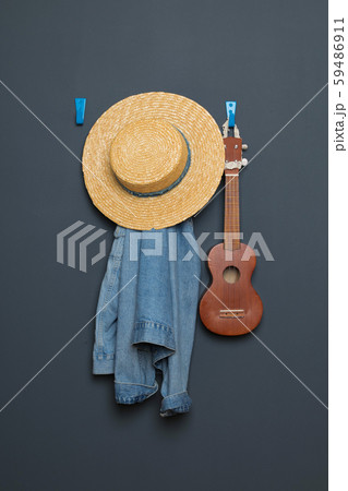 ukulele,denim jacket, straw hat on the background 59486911