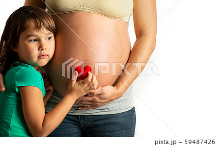 Little girl want to hear her sister heart beat 59487426