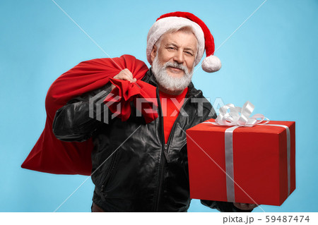 Front view of bearded man in Santa hat with gift boxes 59487474