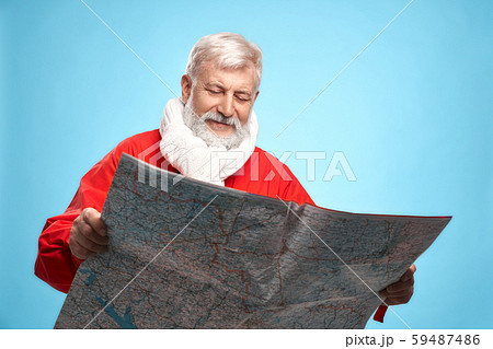 Mature Santa Claus with paper map planning christmas day 59487486
