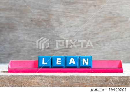 Tile letter on red rack in word lean on wood background Tile letter on red rack in word lean on wood background 59490201