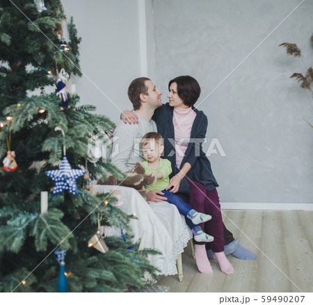 happy family near decorated Christmas tree happy family near decorated Christmas tree 59490207