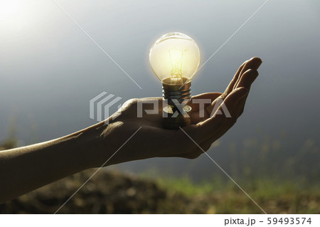 Hand of male holding a light bulb and copy space Hand of male holding a light bulb and copy space 59493574