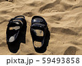 Black sandals on the beach 59493858
