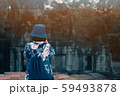 A traveler girl take a picture in Angkor wat 59493878