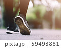 The girl wears black running shoes to run in the 59493881