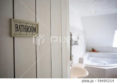 Closeup bathroom door with sign bathroom shallow depth of field, blurred background, white colors 59495214