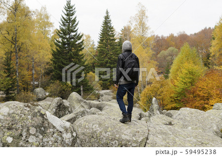 Young man on a volcanic stones in the mountain Young man on a volcanic stones in the mountain 59495238