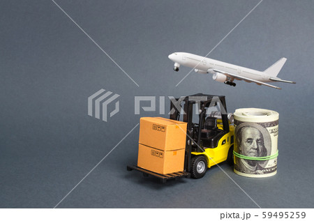 A forklift truck carries cardboard boA forklift truck carries cardboard boxes near a dollar roll and airplane. Transport company. Performance efficient. Trade and production of products and xes near a A forklift truck carries cardboard boA forklift truck carries cardboard boxes near a dollar roll and airplane. Transport company. Performance efficient. Trade and production of products and xes near a 59495259