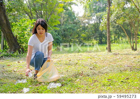 Asian cute girl help to clean the garden by pick the plastic garbage 59495273