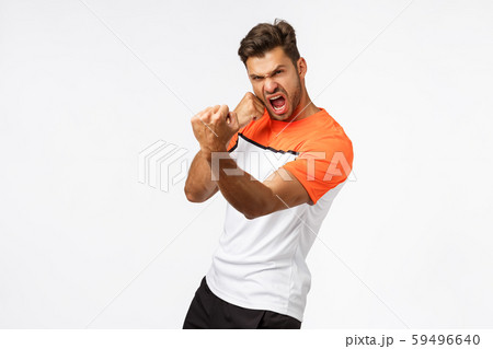 Sport and active lifestyle concept. Serious sexy handsome sportsman with big muscles, showing strong 59496640