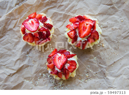 Very tasty muffins with fresh strawberries lie on 59497313