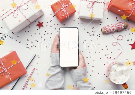 Modern cellphone with white blank screen in woman hands Modern cellphone with white blank screen in woman hands 59497466