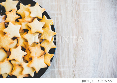 Butter Cookies in black ceramic dish on wood table 59497551