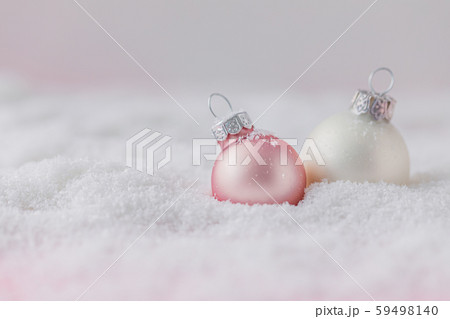 Silver and pink Christmas balls on snowy 59498140