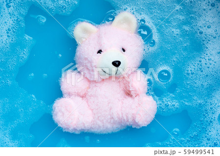Soak  toy bear in laundry detergent water 59499541