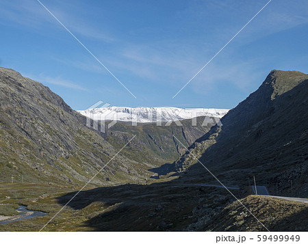 Leirdalen Valley with snow capped mountain peaks, forests, wild river stream and road 55 scenic Leirdalen Valley with snow capped mountain peaks, forests, wild river stream and road 55 scenic 59499949