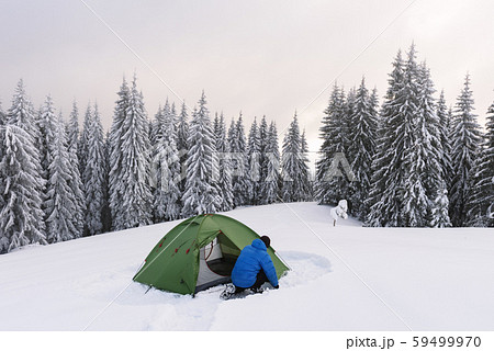 Green tent in winter mountains 59499970