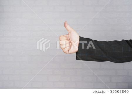 Businessman hand giving thumbs up in the office. Businessman hand giving thumbs up in the office. 59502840