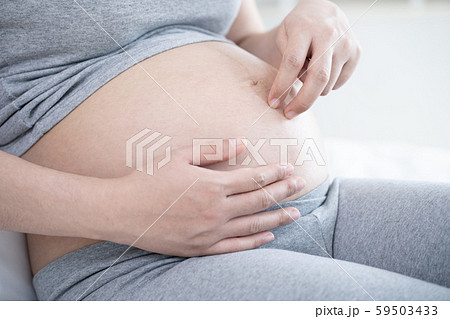 Pregnant woman lying and play fingers walk on her tummy. Pregnant woman lying and play fingers walk on her tummy. 59503433