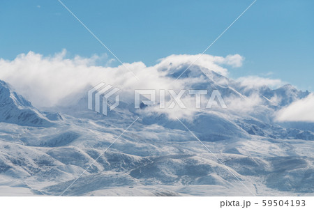 Panoramic snow mountain with white clouds and blue sky 59504193