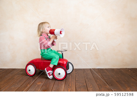Child shouting through vintage megaphone 59512598