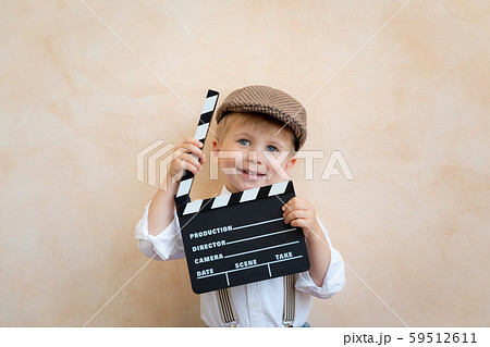 Funny kid holding clapper board 59512611