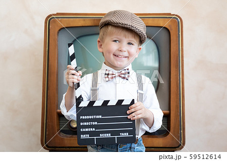 Funny kid holding clapper board 59512614
