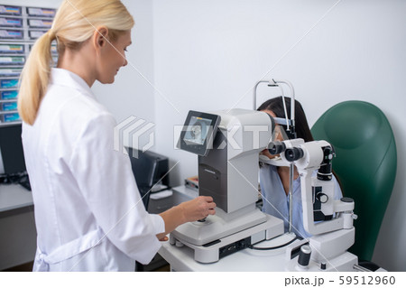 Screen showing eye of patient while eye doctor making examination Screen showing eye of patient while eye doctor making examination 59512960